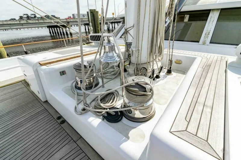  Yacht Photos Pics Deck of 2004 Pendennis 155 yacht with winches and ropes near a dock.