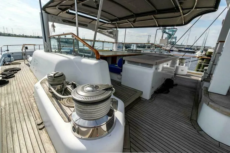  Yacht Photos Pics Luxurious 2004 Pendennis 155 yacht deck with seating and winches, docked at marina.