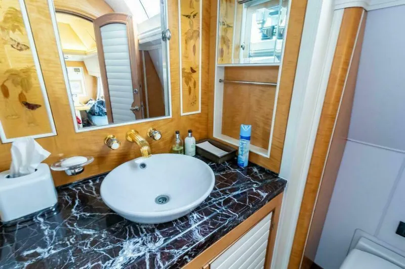  Yacht Photos Pics Luxurious bathroom on Pendennis 155 yacht, featuring elegant marble countertop and modern fixtures.
