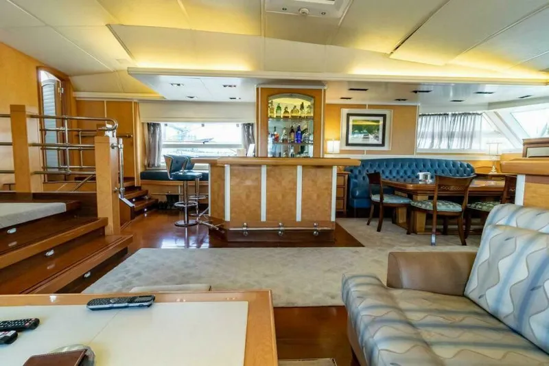  Yacht Photos Pics Luxurious interior of 2004 Pendennis 155 yacht with bar, seating, and elegant decor.