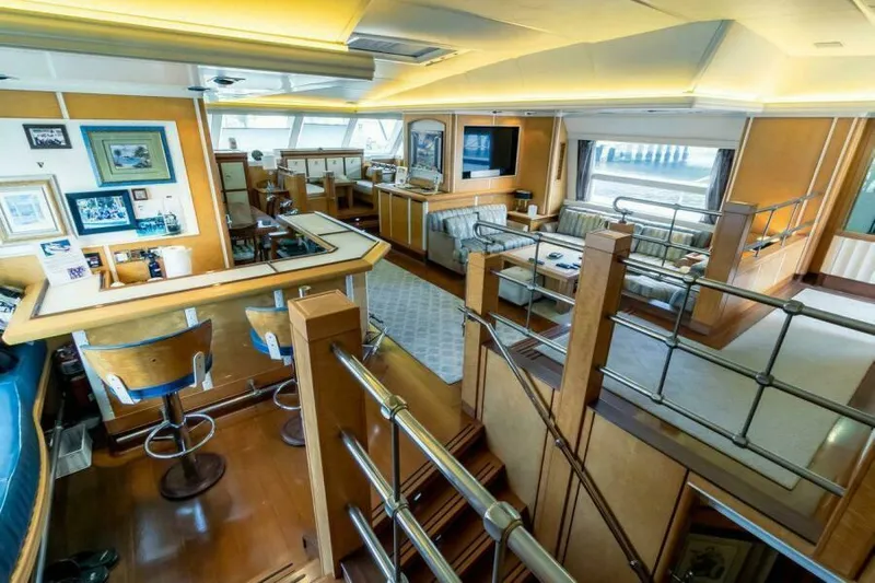  Yacht Photos Pics Luxurious interior of a 2004 Pendennis 155 yacht, featuring elegant wood finishes and modern furnishings.