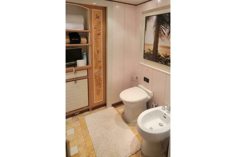  Yacht Photos Pics Luxurious bathroom on Pendennis 155 yacht, 2004 model, featuring elegant decor and ocean-themed artwork.