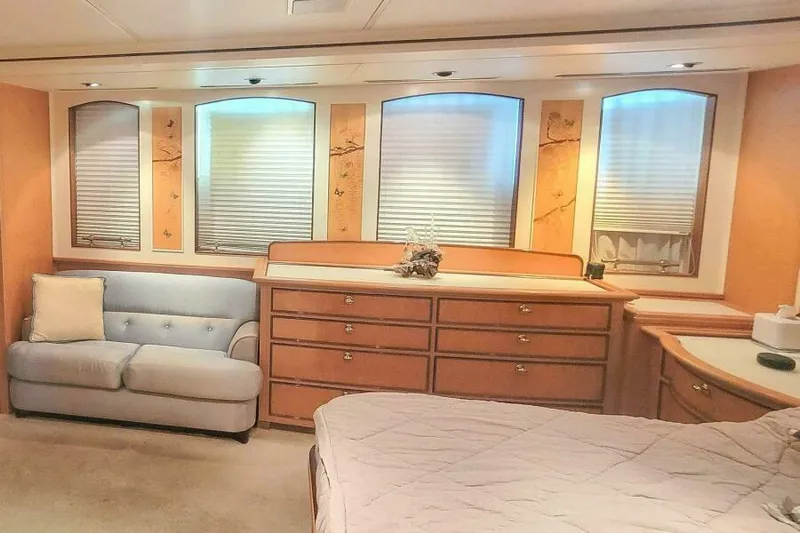  Yacht Photos Pics Luxurious Pendennis 155 yacht interior, featuring elegant wood cabinetry and a cozy seating area, 2004.