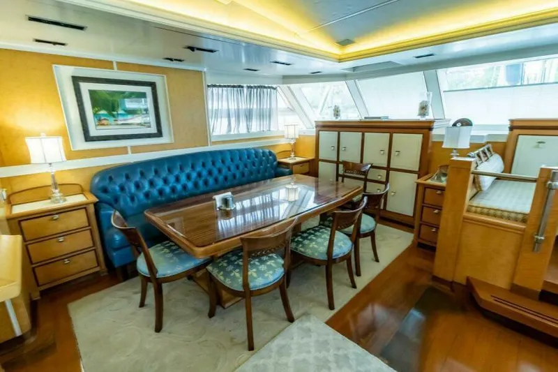  Yacht Photos Pics Luxurious interior of 2004 Pendennis 155 yacht with elegant dining area and plush seating.
