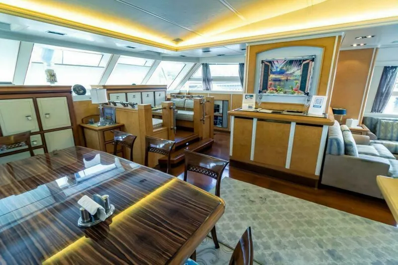  Yacht Photos Pics Luxurious interior of 2004 Pendennis 155 yacht with elegant dining and seating areas.