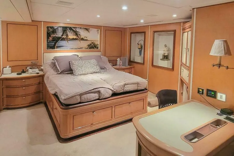  Yacht Photos Pics Luxurious bedroom interior on Pendennis 155 yacht, 2004 model, featuring elegant wood furnishings.