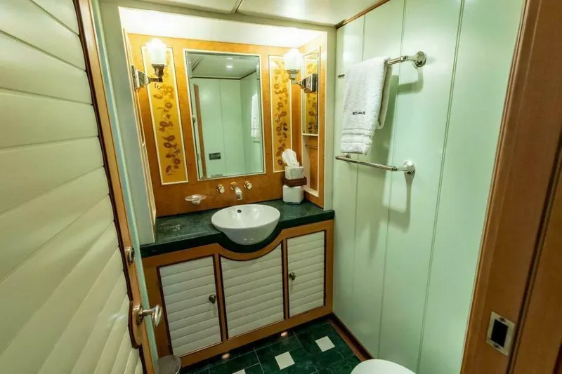  Yacht Photos Pics Luxurious bathroom in 2004 Pendennis 155 yacht with elegant fixtures and decor.