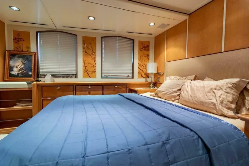  Yacht Photos Pics Luxurious bedroom interior on Pendennis 155 yacht, 2004 model, featuring elegant decor and cozy bedding.
