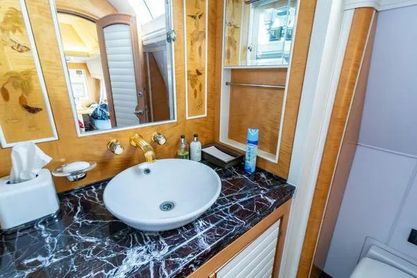 Yacht Photos Pics Luxurious bathroom on 2004 Pendennis 155 yacht with marble countertop and elegant fixtures.