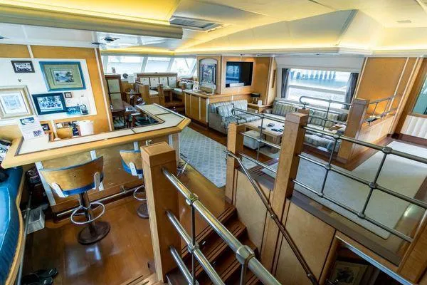  Yacht Photos Pics Luxurious interior of 2004 Pendennis 155 yacht with elegant furnishings and bar area.
