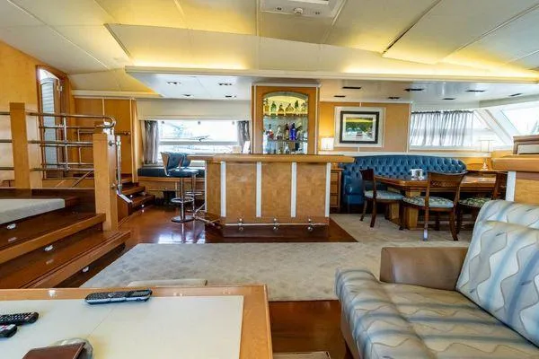  Yacht Photos Pics Luxurious interior of 2004 Pendennis 155 yacht with bar, seating, and elegant decor.