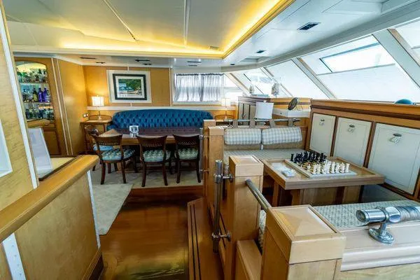  Yacht Photos Pics Luxurious interior of 2004 Pendennis 155 yacht with elegant dining and chess area.