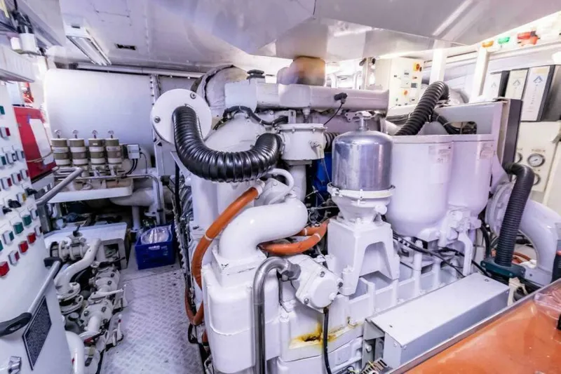  Yacht Photos Pics Engine room of a 2004 Pendennis 155 yacht, showcasing complex machinery and control panels.