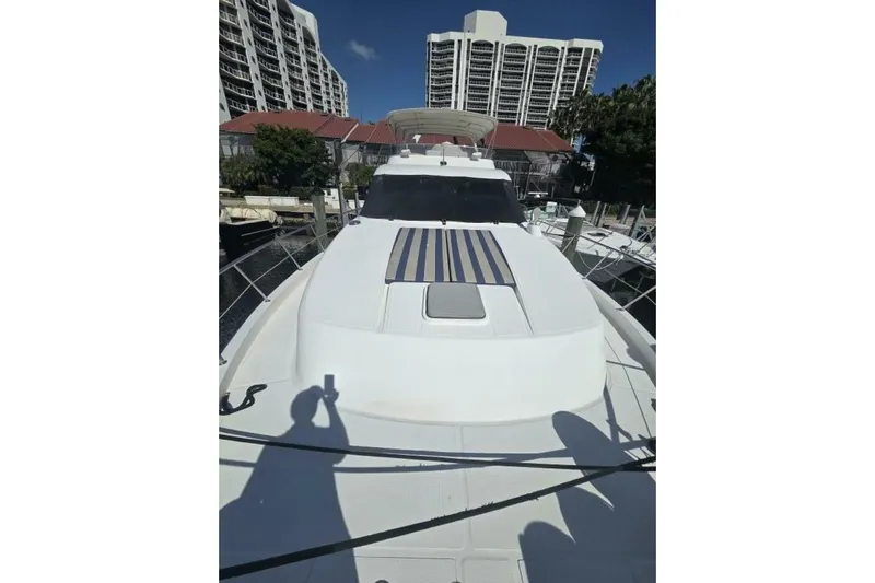 Always Something Yacht Photos Pics 2009 Grand Harbour 66 Motoryacht docked near high-rise buildings.