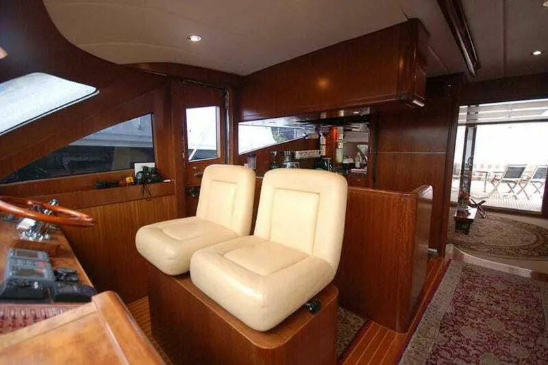 Always Something Yacht Photos Pics Luxurious interior of 2009 Grand Harbour 66 Motoryacht with plush seating and elegant wood finish.