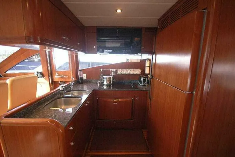 Always Something Yacht Photos Pics Luxurious kitchen interior of 2009 Grand Harbour 66 Motoryacht with wooden cabinetry and modern appliances.