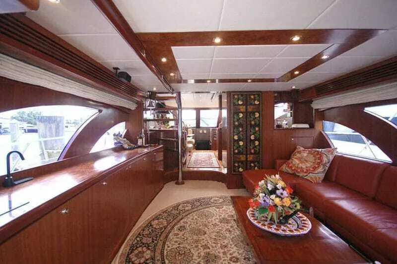 Always Something Yacht Photos Pics Luxurious interior of 2009 Grand Harbour 66 Motoryacht with elegant wood finishes and floral decor.