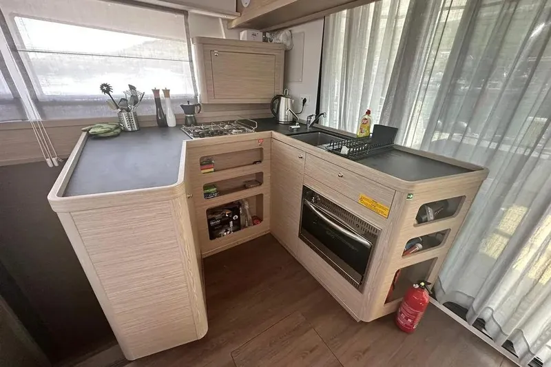 Jack Yacht Photos Pics Modern kitchen in 2024 Lagoon 42 yacht with sleek countertops and appliances.