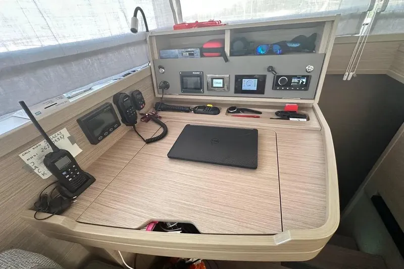 Jack Yacht Photos Pics Navigation station inside 2024 Lagoon 42 catamaran with communication equipment and laptop.