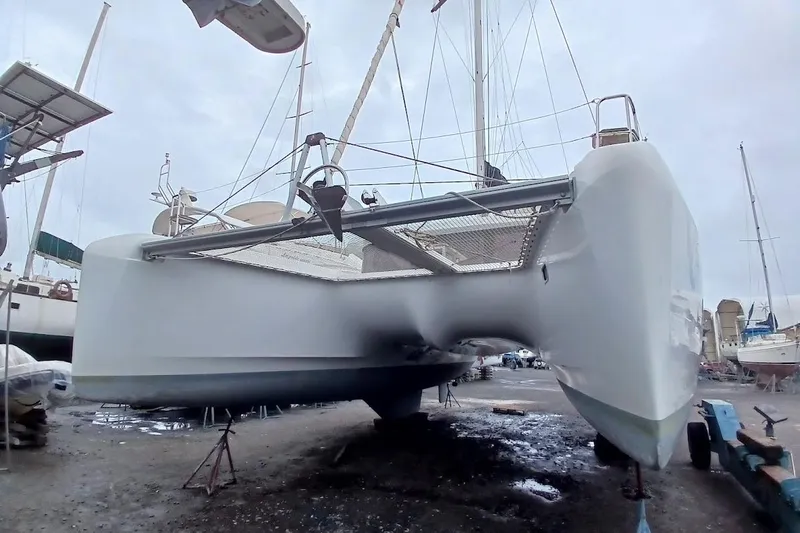 Jack Yacht Photos Pics 2024 Lagoon 42 catamaran on dry dock, showcasing sleek hull design and modern features.