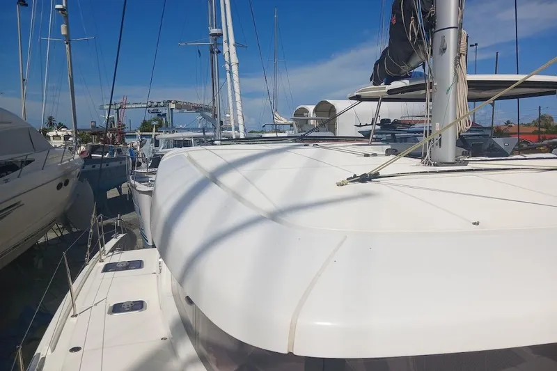 Jack Yacht Photos Pics 2024 Lagoon 42 catamaran docked at marina under clear blue sky.