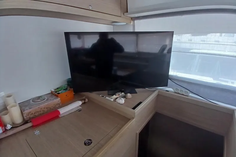Jack Yacht Photos Pics Interior of 2024 Lagoon 42 yacht with TV and decorative items.