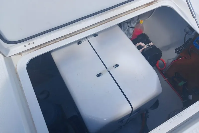 Jack Yacht Photos Pics Open storage compartment on 2024 Lagoon 42 catamaran, showing equipment and wiring.