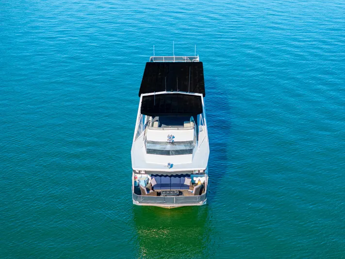  Yacht Photos Pics 1998 Stardust Cruisers Custom Luxury Houseboat on clear blue water, aerial view.