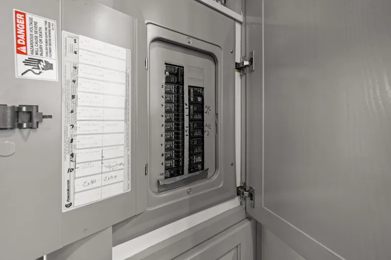  Yacht Photos Pics Electrical panel inside 1998 Stardust Cruisers Custom Luxury Houseboat, featuring circuit breakers and safety warnings.