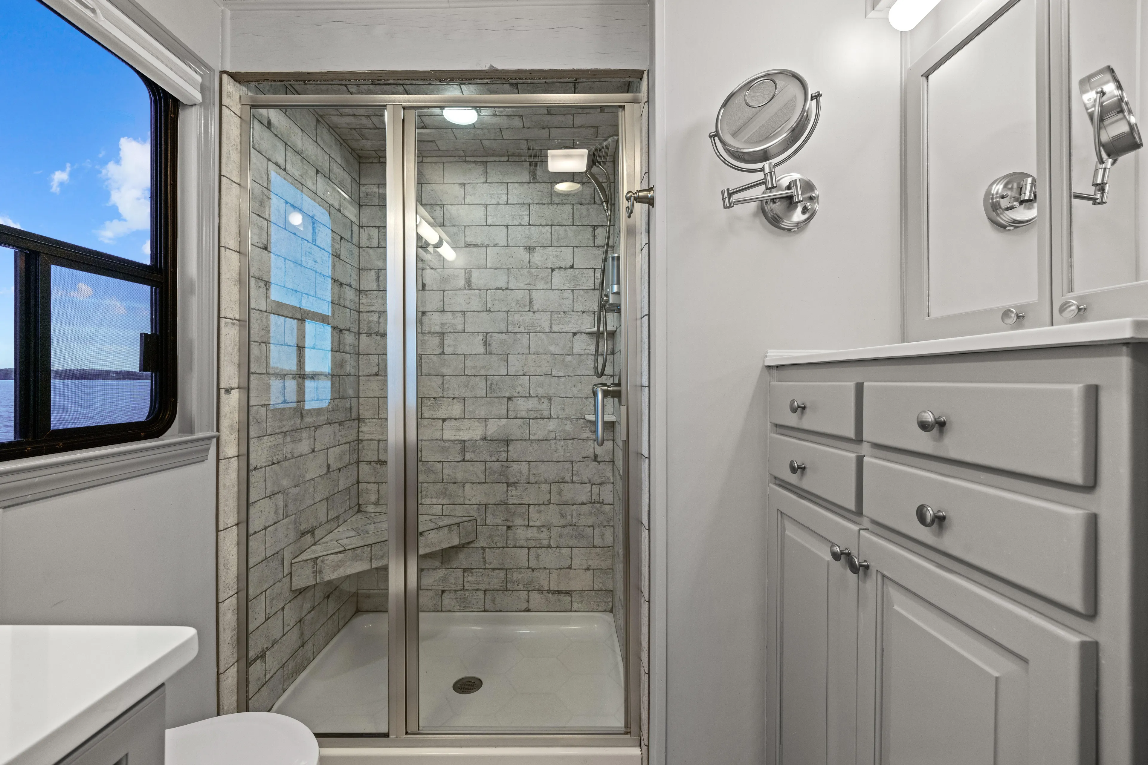  Yacht Photos Pics Luxurious bathroom in 1998 Stardust Cruisers houseboat with modern shower and elegant cabinetry.