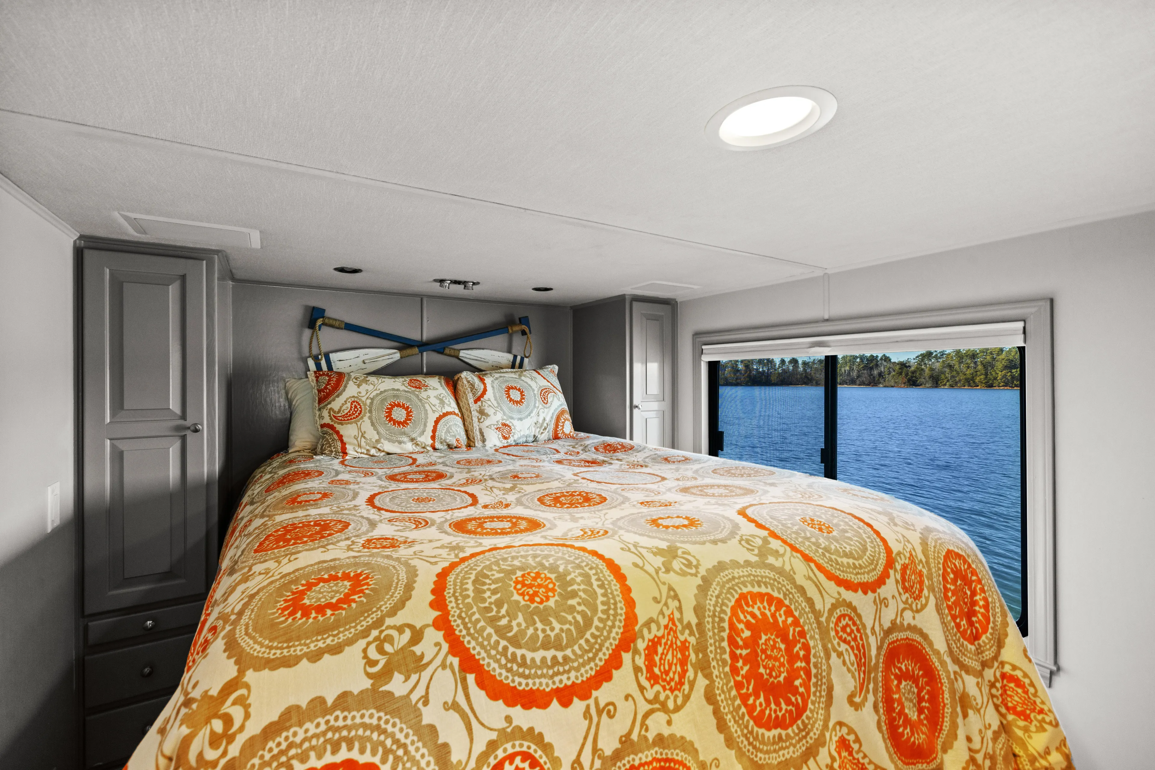  Yacht Photos Pics Luxurious bedroom in 1998 Stardust Cruisers houseboat with vibrant bedding and scenic water view.