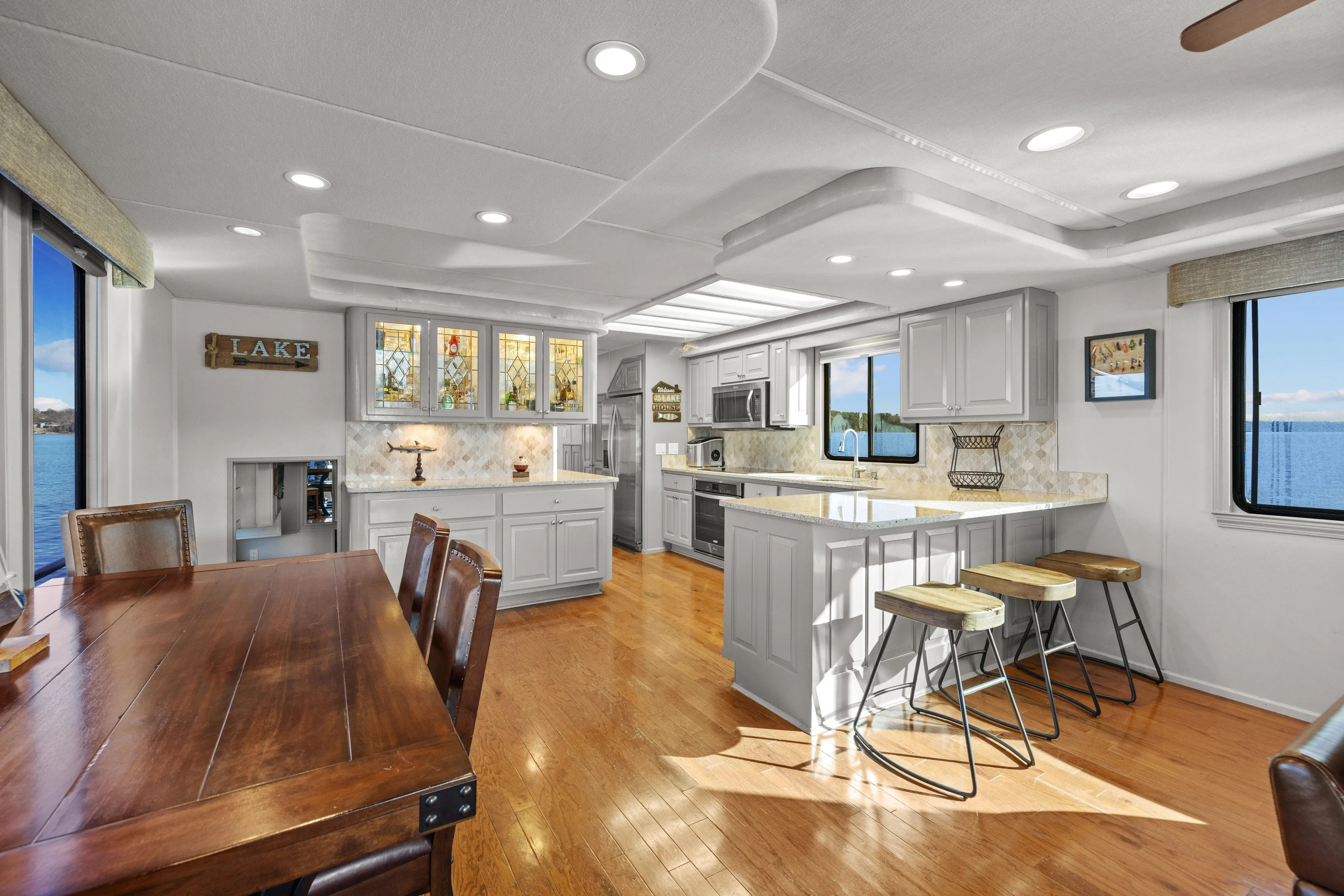  Yacht Photos Pics Luxurious 1998 Stardust Cruisers houseboat interior with modern kitchen and dining area, lake view.