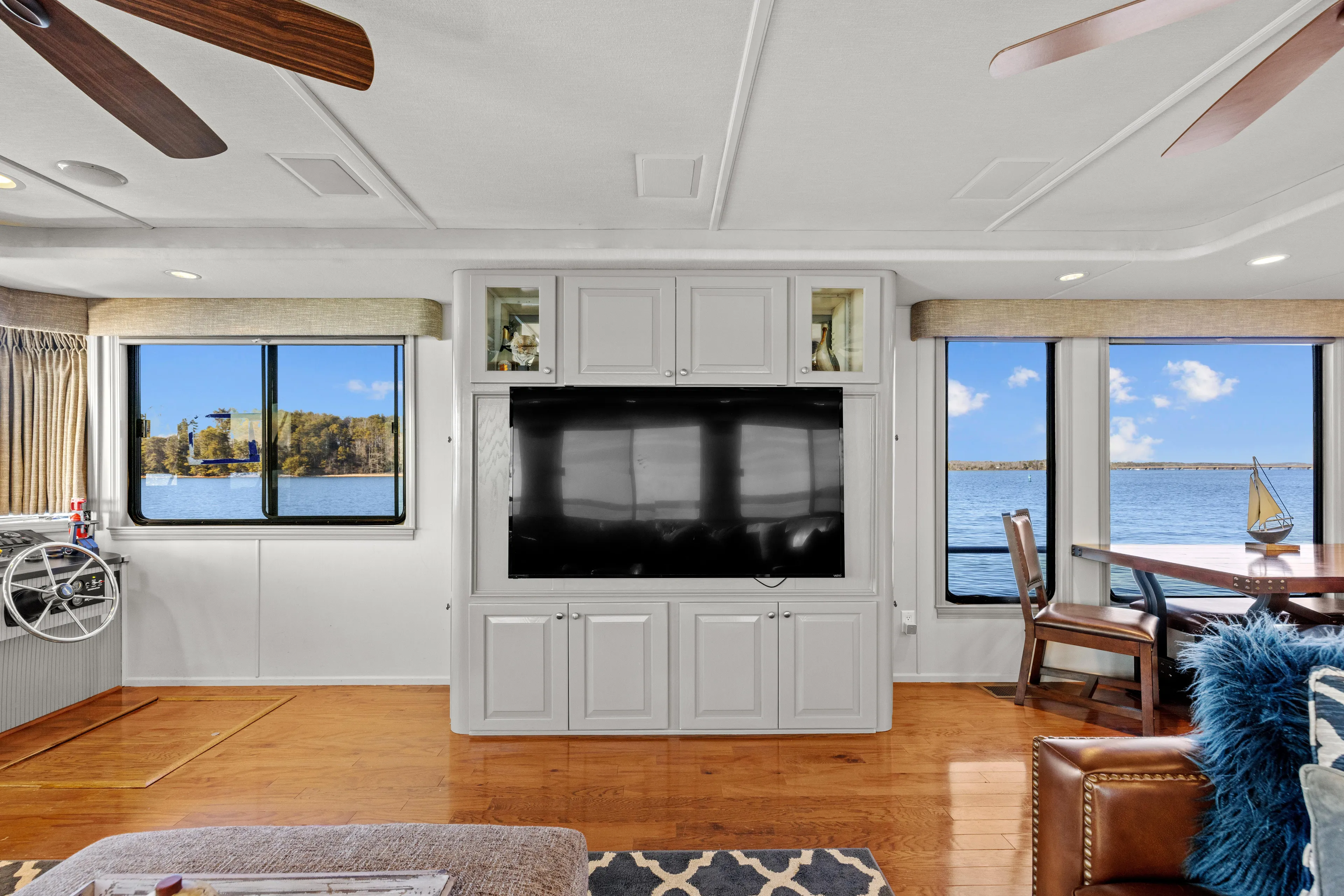  Yacht Photos Pics Luxurious 1998 Stardust Cruisers houseboat interior with lake view, featuring modern entertainment center.