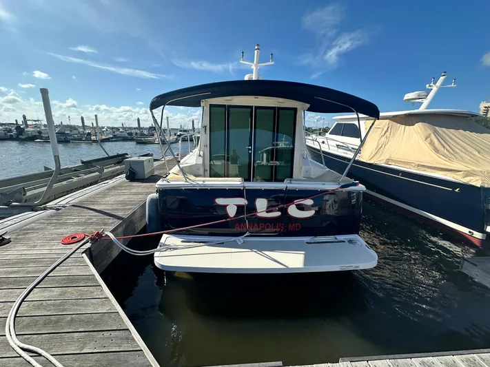 Tlc Yacht Photos Pics 2014 Back Cove 37 boat docked in Annapolis marina under clear blue sky.