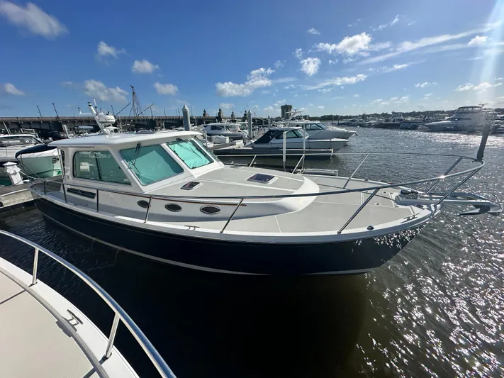 Tlc Yacht Photos Pics 2014 Back Cove 37 boat docked at marina under clear blue sky.