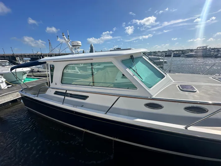 Tlc Yacht Photos Pics 2014 Back Cove 37 boat docked at marina under clear blue sky.