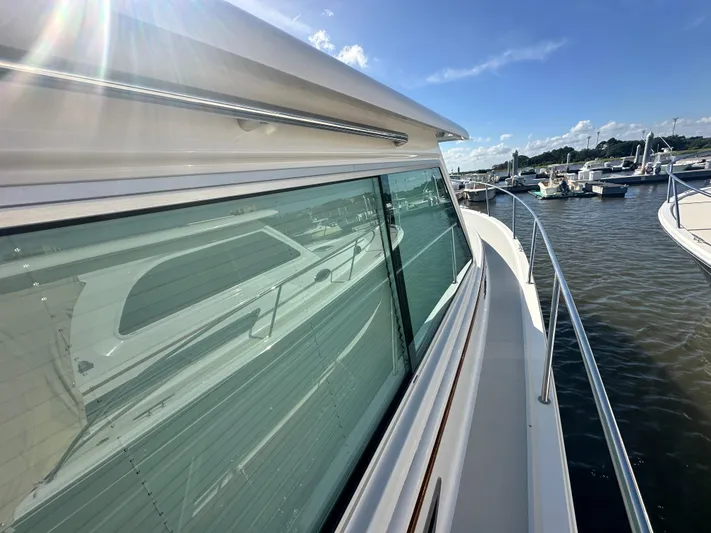 Tlc Yacht Photos Pics 2014 Back Cove 37 yacht docked, reflecting sunlight on calm water.