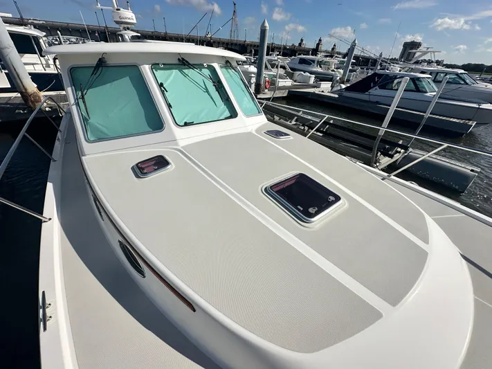 Tlc Yacht Photos Pics 2014 Back Cove 37 boat docked at marina, showcasing sleek design and windows.