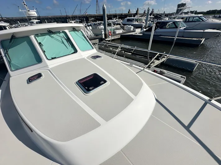 Tlc Yacht Photos Pics 2014 Back Cove 37 yacht docked at marina, showcasing sleek deck design.