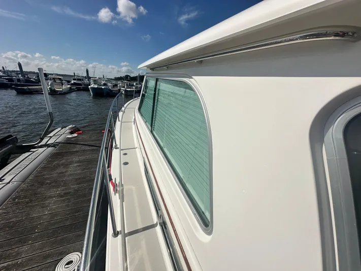 Tlc Yacht Photos Pics 2014 Back Cove 37 yacht docked at marina under clear blue sky.