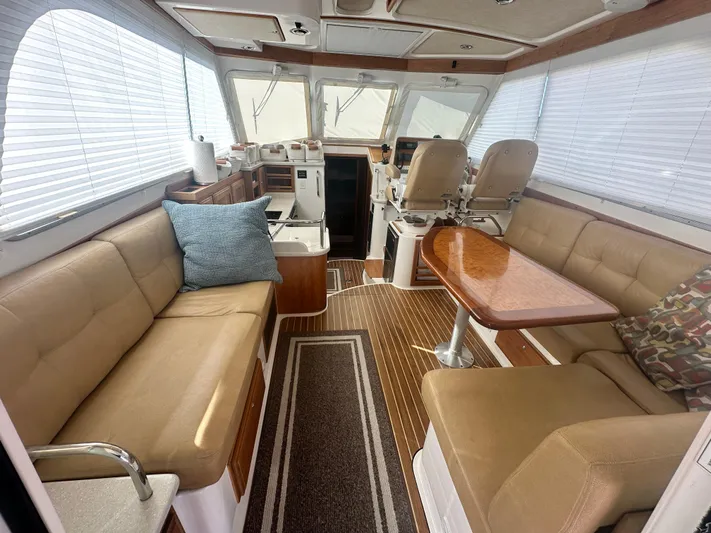 Tlc Yacht Photos Pics Interior of 2014 Back Cove 37 yacht with beige seating and wooden table.