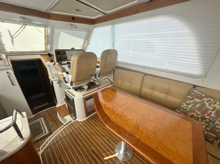 Tlc Yacht Photos Pics Interior of 2014 Back Cove 37 yacht with helm, seating, and wooden table.