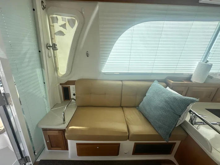 Tlc Yacht Photos Pics Interior of a 2014 Back Cove 37 boat with beige seating and blue cushion.