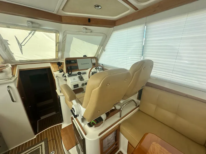 Tlc Yacht Photos Pics Interior of 2014 Back Cove 37 boat with helm, beige seating, and Garmin navigation system.