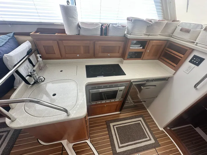 Tlc Yacht Photos Pics 2014 Back Cove 37 yacht kitchen with modern appliances, wooden cabinets, and countertop.