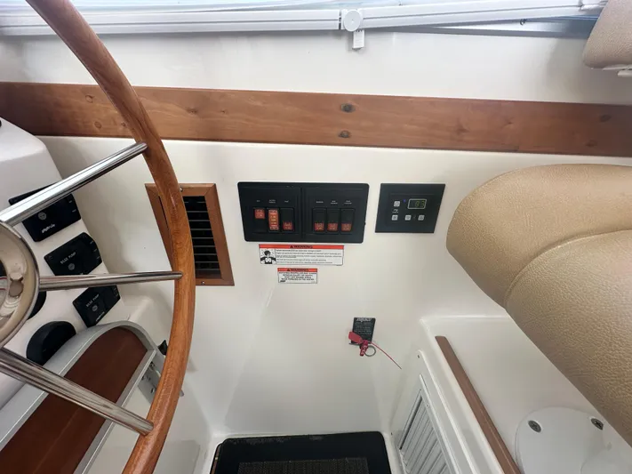 Tlc Yacht Photos Pics 2014 Back Cove 37 helm with wooden steering wheel and control panel.