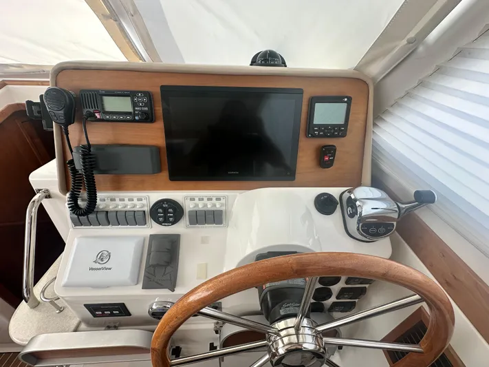 Tlc Yacht Photos Pics Helm of 2014 Back Cove 37 boat with steering wheel, controls, and navigation equipment.