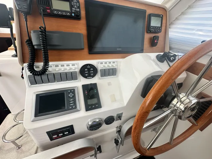 Tlc Yacht Photos Pics Helm of 2014 Back Cove 37 boat with navigation equipment and wooden steering wheel.