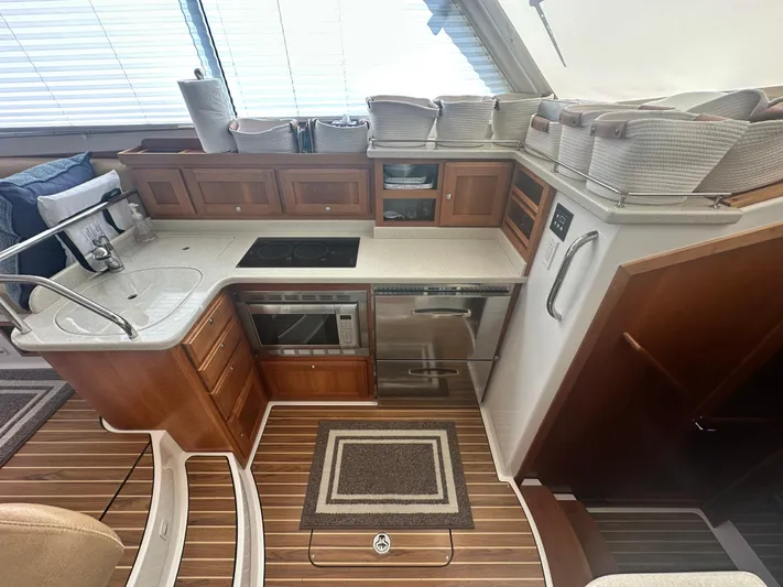 Tlc Yacht Photos Pics Luxurious 2014 Back Cove 37 yacht kitchen with modern appliances and elegant wood cabinetry.