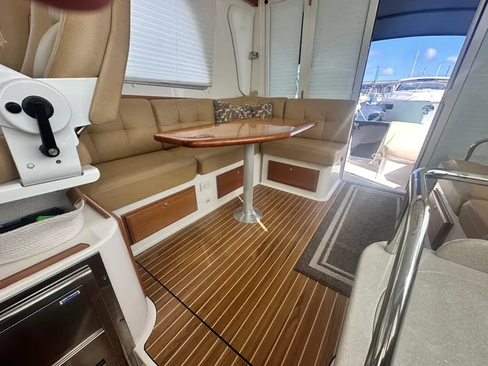 Tlc Yacht Photos Pics Interior of 2014 Back Cove 37 yacht with seating, table, and wood flooring.